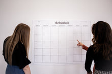 Load image into Gallery viewer, large wall calendar for activities or schedules with women pointing and planning